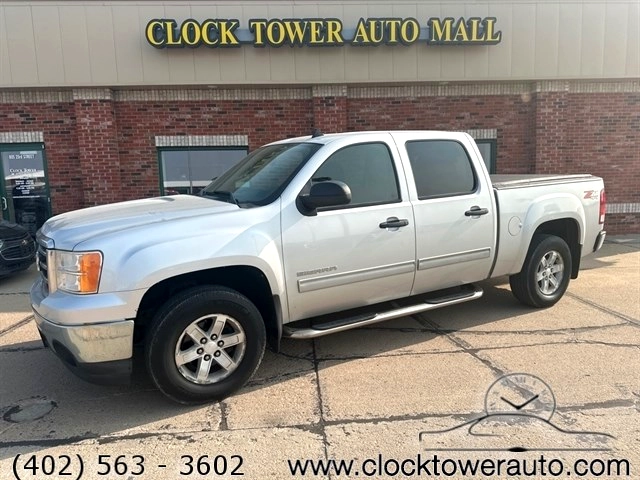 2012 GMC Sierra  Sierra in front of Clock Tower Mall Used car business