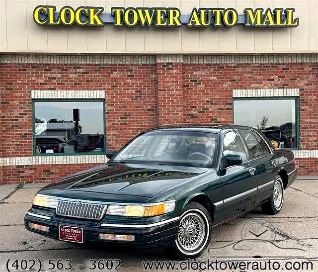 1993 Mercury Grand Marquis  Grand Marquis in front of Clock Tower Mall Used car business